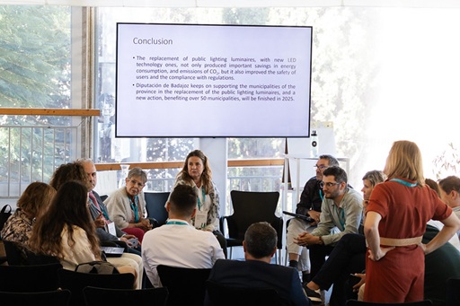 Group of people looking at screen and talking