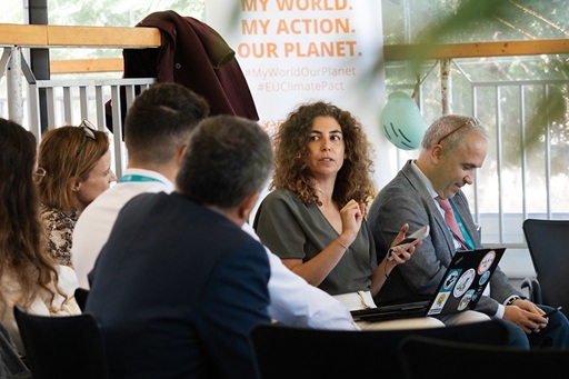 People discussing in a small group with focus on a woman