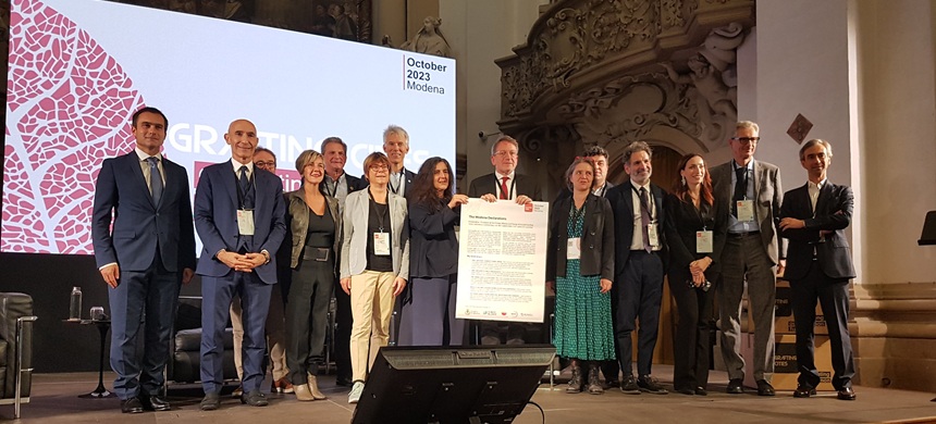 Group of people on stage presenting declaration