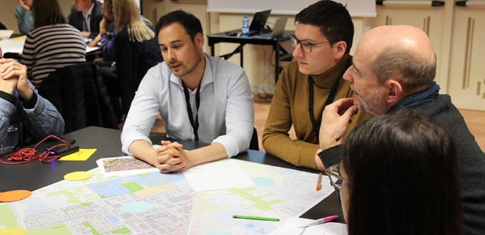 People sitting at table discussing with eachother