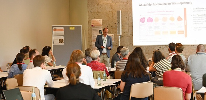 People sitting in a workshop and listening to presentation