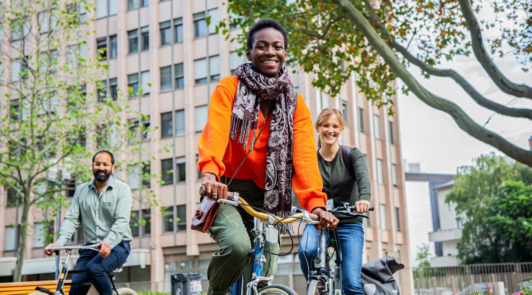 Three people on bikes in a city